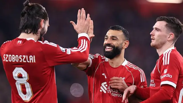Liverpool players celebrate a goal