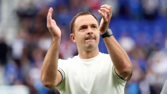 Chris Davies clapping to the fans