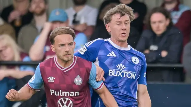 Buxton's George Ward (R) takes on Todd Alcock of South Shields in the National League North play-offs
