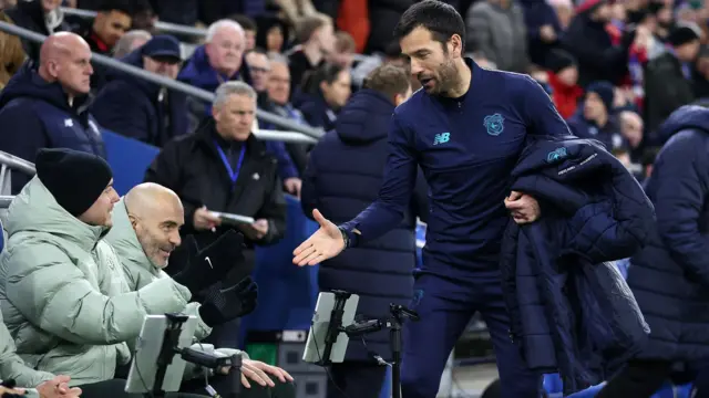 Brian Barry-Murphy goes to shake hands with Enzo Maresca before Cardiff's game against Chelsea