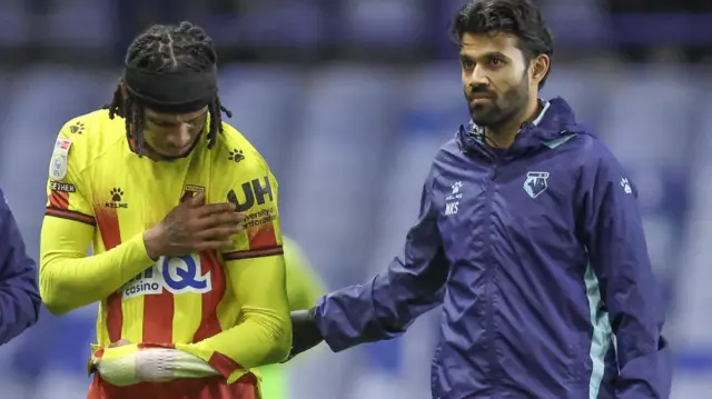 Jeremy Petris is helped off the field by a physio