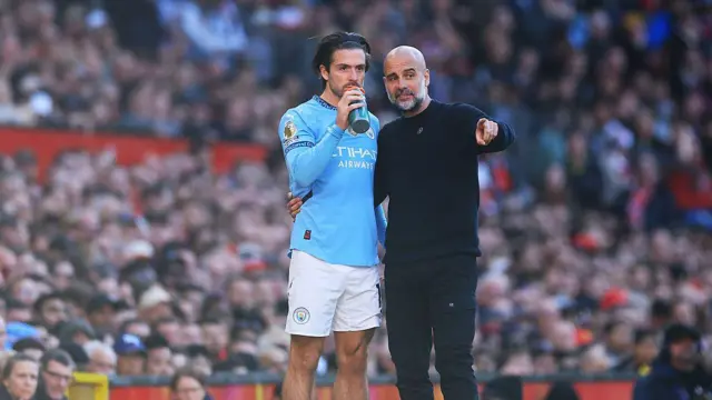 Pep Guardiola gives instructions to Jack Grealish