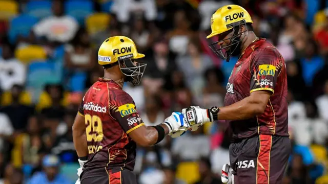 Nicholas Pooran and Kieron Pollard punch gloves