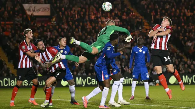 Filip Jorgensen attempts to punch the ball