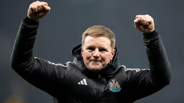 Eddie Howe celebrates with his arms in the air
