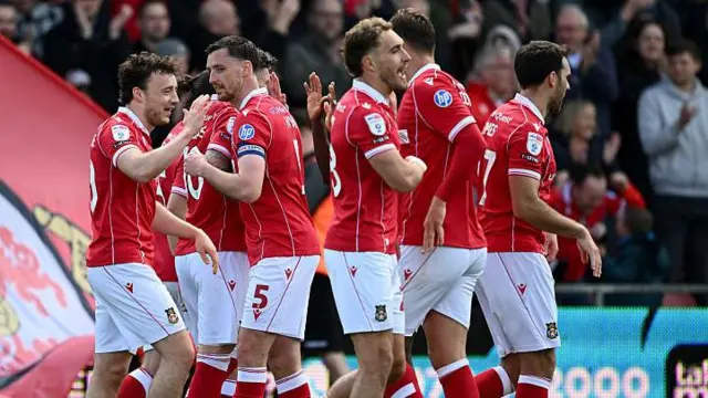 Wrexham players (left to right) Ollie Rathbone, Dom Hyam, Sam Smith and Matty James celebrate