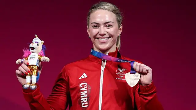 Laura Hughes, who returned to weightlifting after taking a break from the sport, poses with her bronze medal