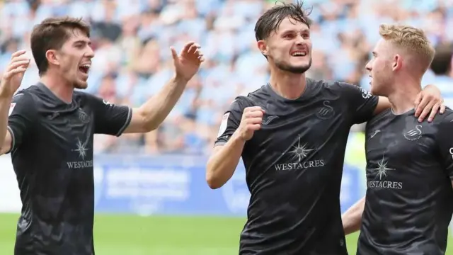 Liam Cullen, Josh Key and Ollie Cooper celebrate Cooper's goal