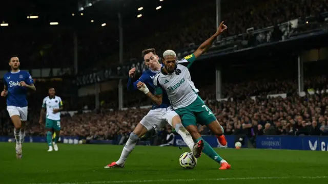 Everton midfielder James Garner defends from Newcastle midfielder Joelinton