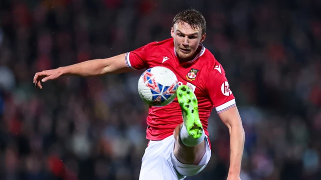 Sam Dalby reaching out for the ball while playing for Wrexham.