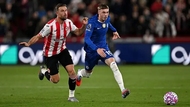 Cole Palmer of Chelsea is challenged by Jordan Henderson of Brentford