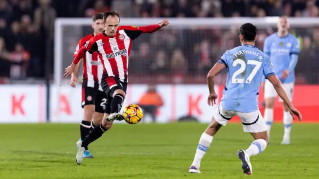 Mikkel Damsgaard of Brentford takes on Manchester City's Matheus Nunes