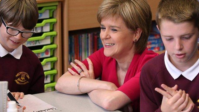 First Minister Nicola Sturgeon sits with school children