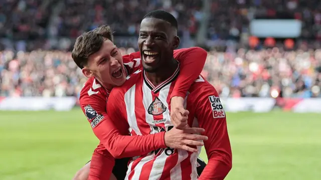 Nordi Mukiele celebrates with Chris Rigg