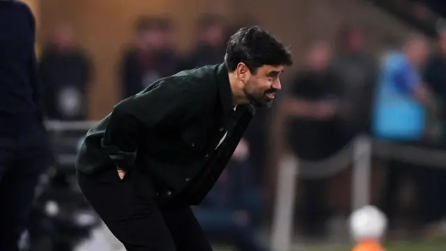 Vitor Matos crouches on the touchline during Swansea's defeat to Coventry