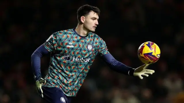 Max O'Leary goes to kick the ball out of his hand during a match