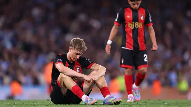 Dean Huijsen sits on the floor dejected