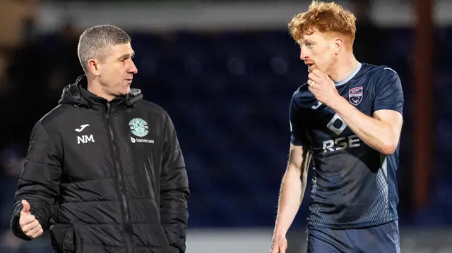 Hibernian Manager Nick Montgomery (L) speaks with Ross County's Simon Murray at full time during a cinch Premiership match between Ross County and Hibernian at the Global Energy Stadium