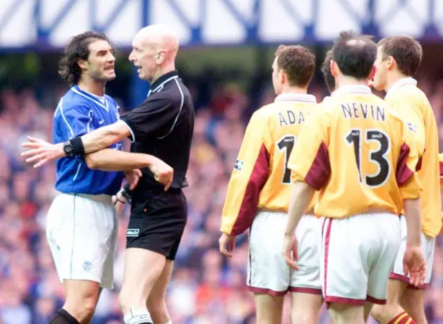 Motherwell players watch on as Rangers captain Lorenzo Amoruso (left) argues with referee John Rowbotham