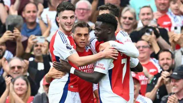 Declan Rice, Leandro Trossard and Bukayo Saka celebrate the Arsenal goal, scored by Kai Havertz during the Premier League match between Arsenal FC and Brighton & Hove Albion FC.