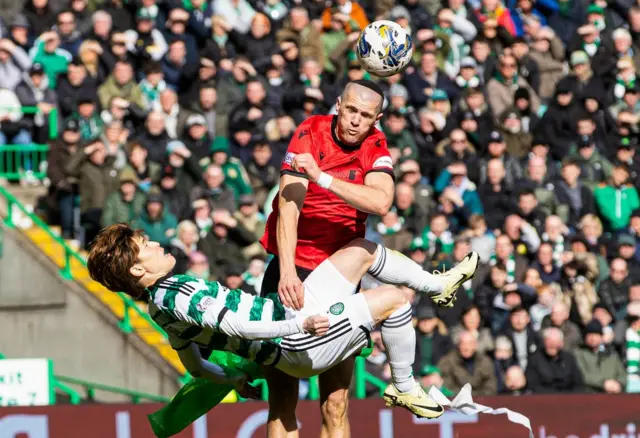 St Mirren's Alex Gogic heads clear under pressure from Kyogo Furuhashi