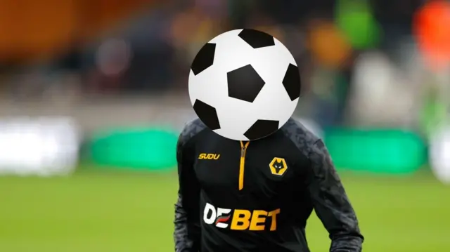 A Wolverhampton Wanderers' player hidden behind a football