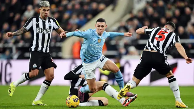 Phil Foden drives forward with the ball against Newcastle United.