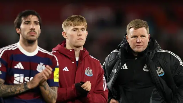 Eddie Howe and his players applaud the travelling fans after their defeat to Brentford