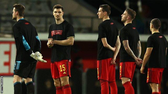 Belgium's players lined up in T-shirts with the words "football supports change" before kick-off