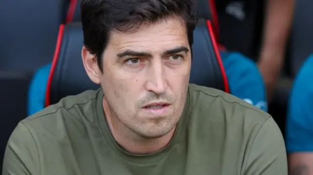 Andoni Iraola sits in the dugout