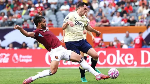 Lucas Paqueta challenges Michael Keane