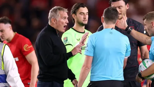 Phil Parkinson, manager of Wrexham, speaks to the match officials at the end of the Carabao Cup first-round match between Middlesbrough and Wrexham at Riverside Stadium