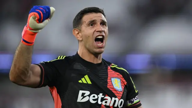 Emiliano Martinez of Aston Villa punches the air