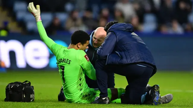 Sheffield Wednesday goalkeeper Pierce Charles looking in pain as he receives treatment for a shoulder injury during their game against Brentford in the FA Cup