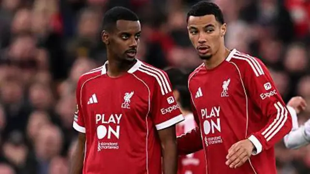 Alexander Isak and Hugo Ekitike talking on the pitch during a Liverpool game