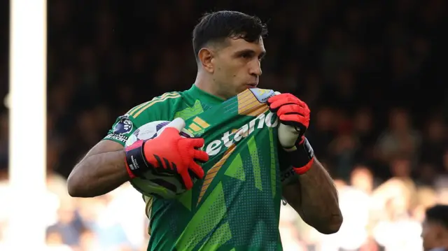 Emiliano Martinez kisses the Aston Villa badge