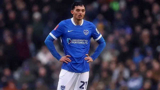 Andre Dozzell with his hands on his hips while in action for Portsmouth