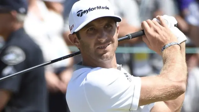 Dustin Johnson hits a tee shot