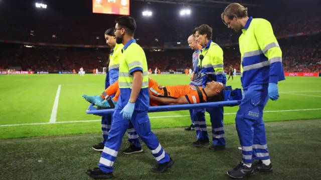 Nathan Ake of Netherlands leaves the pitch on a stretcher