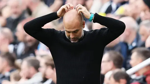 Pep Guardiola with his hands on his head