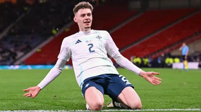 Conor Bradley celebrates scoring for Northern Ireland against Scotland in March