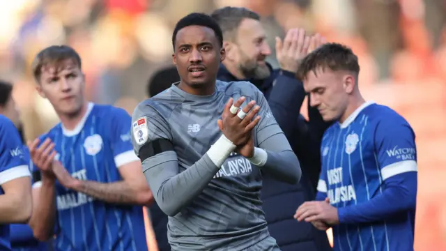 Nathan Trott and Cardiff team-mates applaud the fans