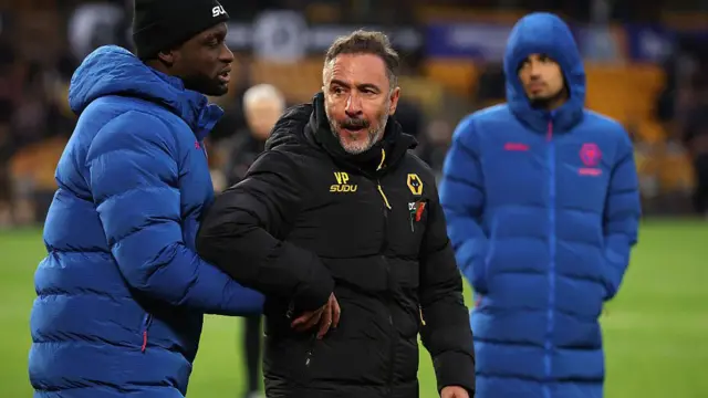 Vitor Pereira being held after clashing with supporters after Wolves' home defeat by Burnley