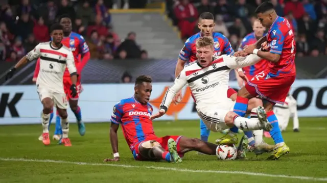 Rasmus Hojlund is challenged in the penalty area