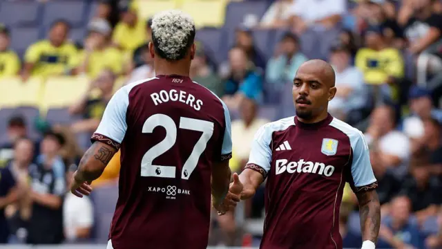 Donyell Malen gets a high five from Morgan Rogers after scoring