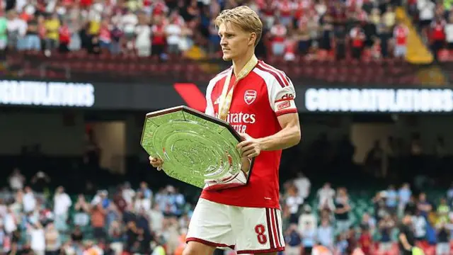Arsenal captain Martin Odegaard holding the Community Shield trophy