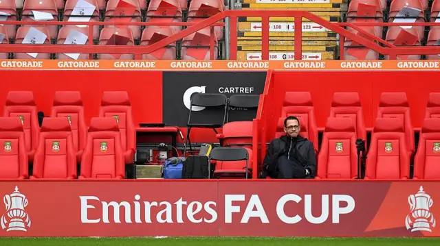 Liam Rosenior sits in the dugout before the fifth round win over Wrexham