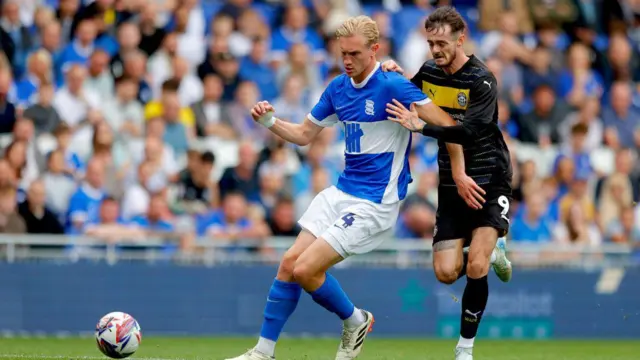 Joe Hugill of Wigan chases the ball