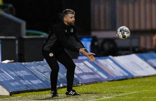 St Mirren manager Stephen Robinson throwing the match ball back on the park during today's victory over Ross County