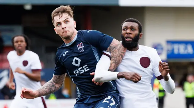  Ross County's Eamonn Brophy and Hearts' Beni Baningime